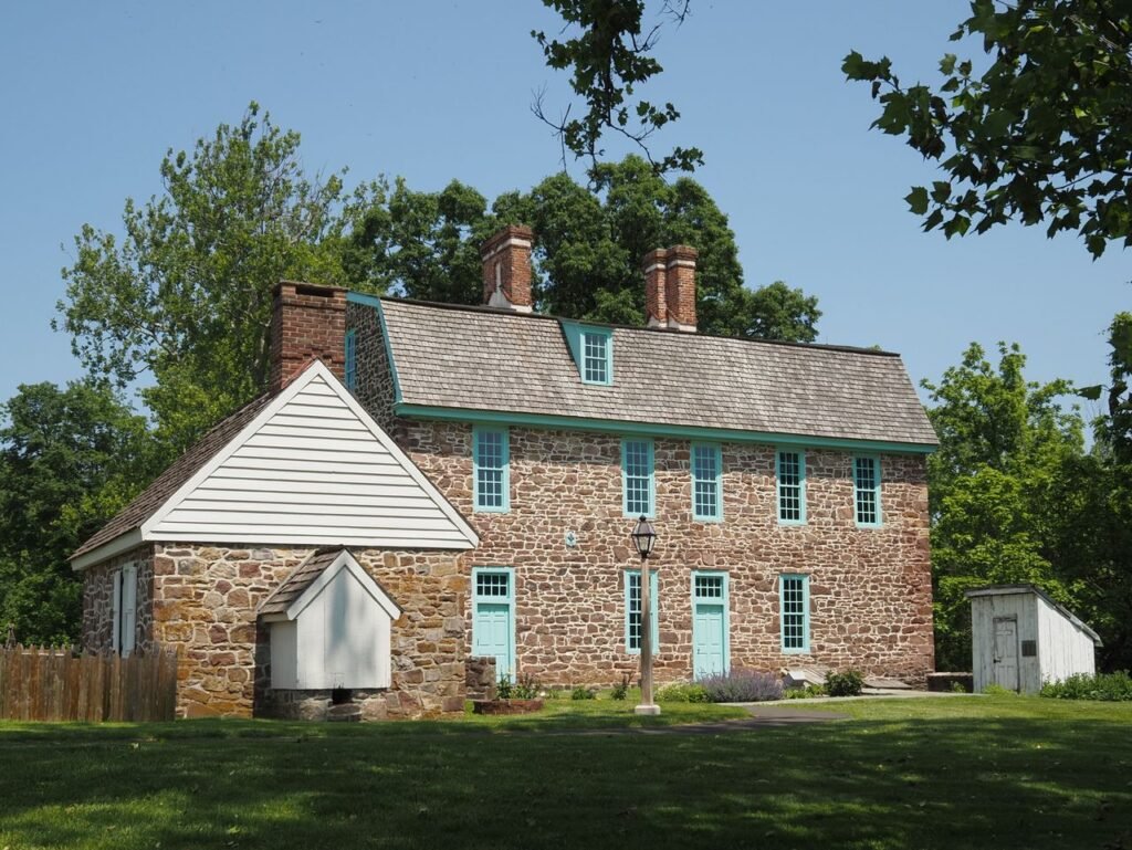 A charming historic stone house in a lush summer setting in Horsham, PA.