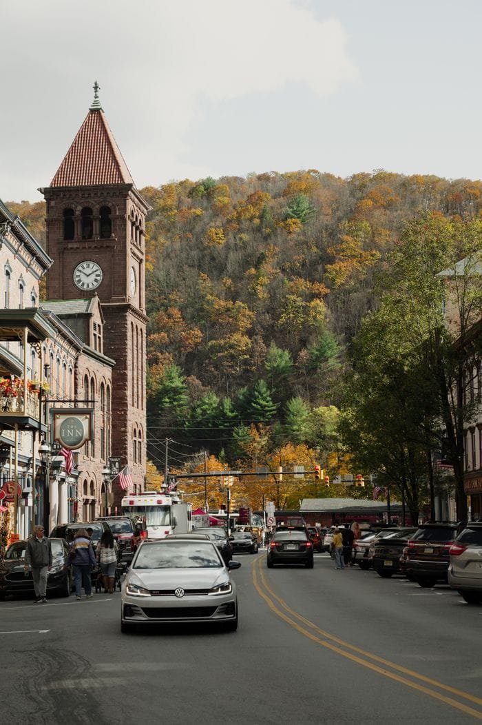 Scenic view of a street with a clock tower surrounded by autumn foliage in Jim Thorpe, PA.